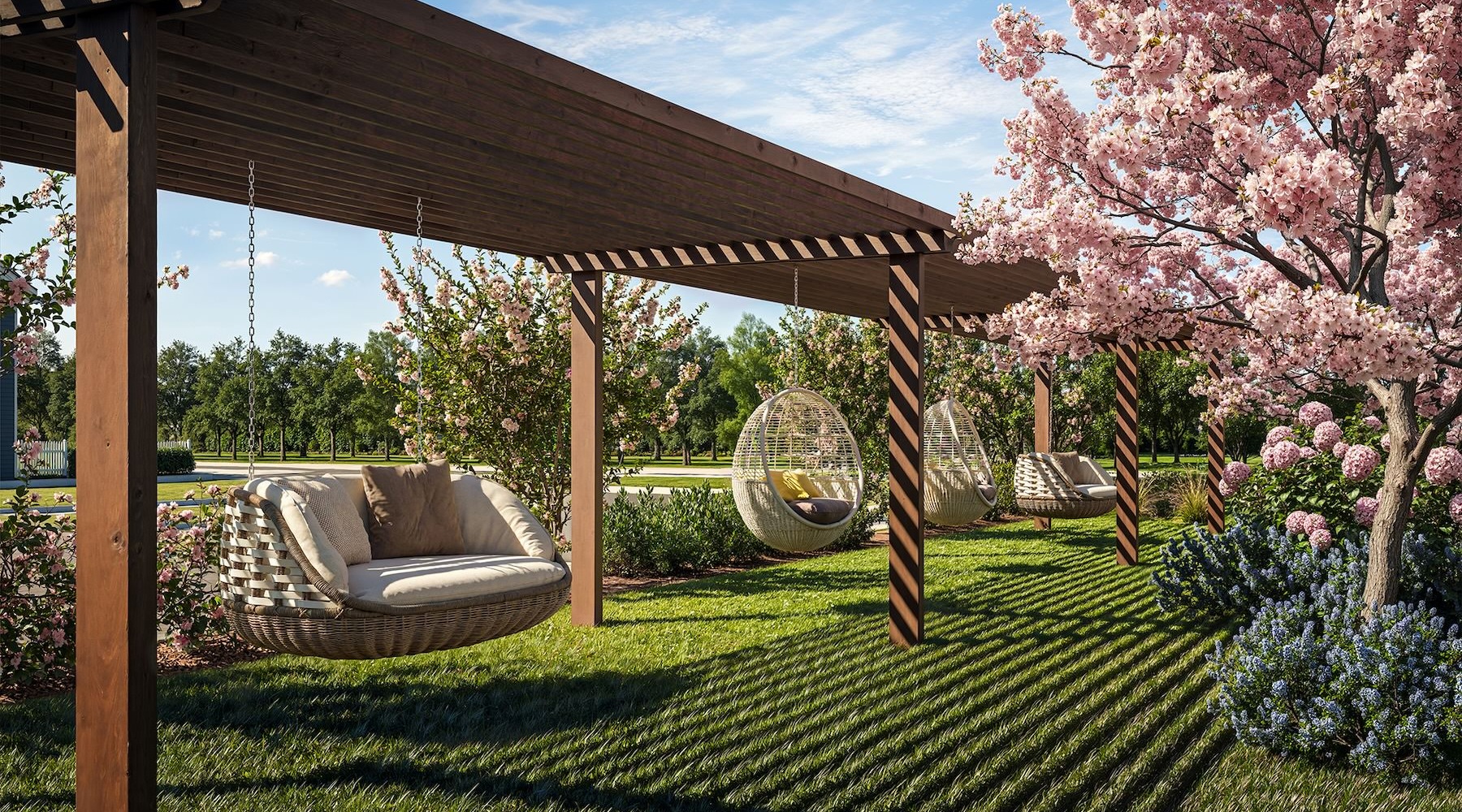 a grassy area with trees and hanging chairs
