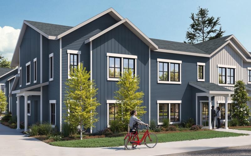 a person riding a bicycle in front of a building