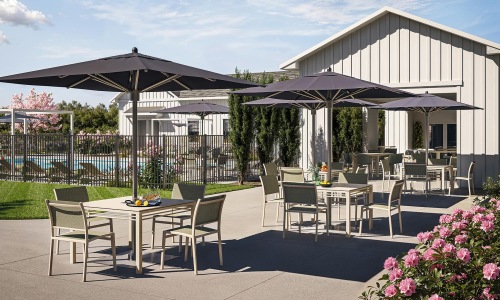 a patio with tables and chairs