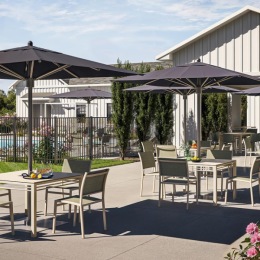 a patio with tables and chairs