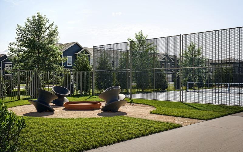 an outside lounge with chairs in front of a pickleball court