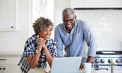 a man and woman looking at a computer