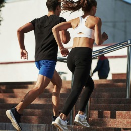 a man and woman running up stairs
