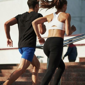 a man and woman running up stairs