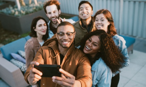friends take a group selfie outdoors