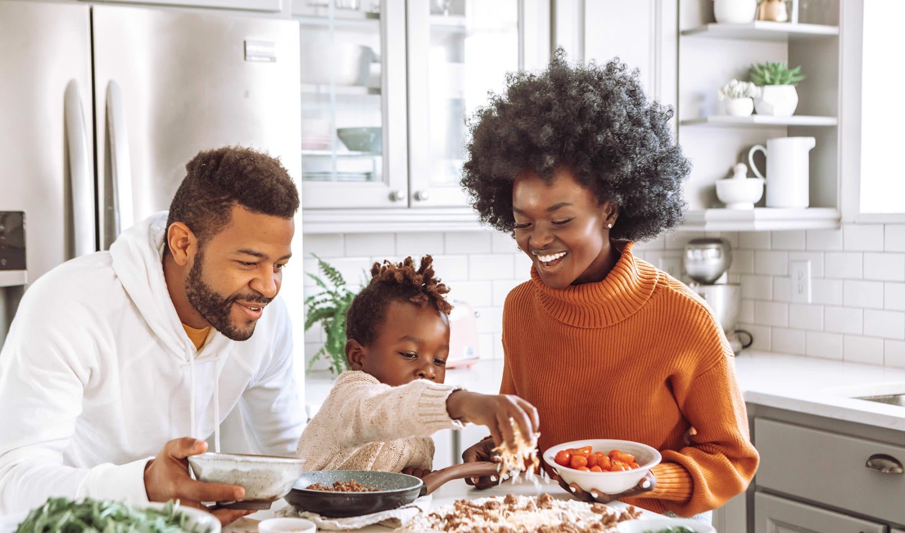 a family eating food in a kitchen